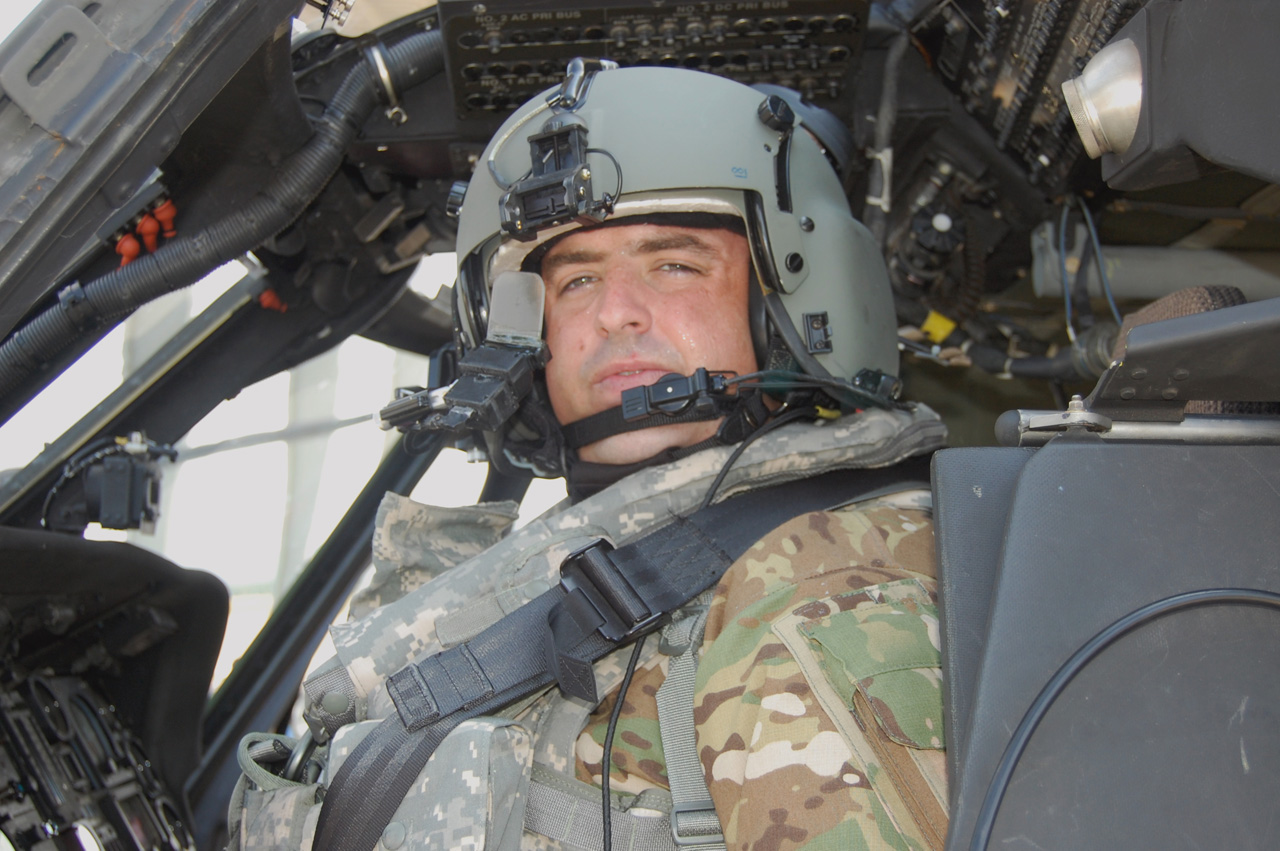 Military pilot in flight helmet inside cockpit